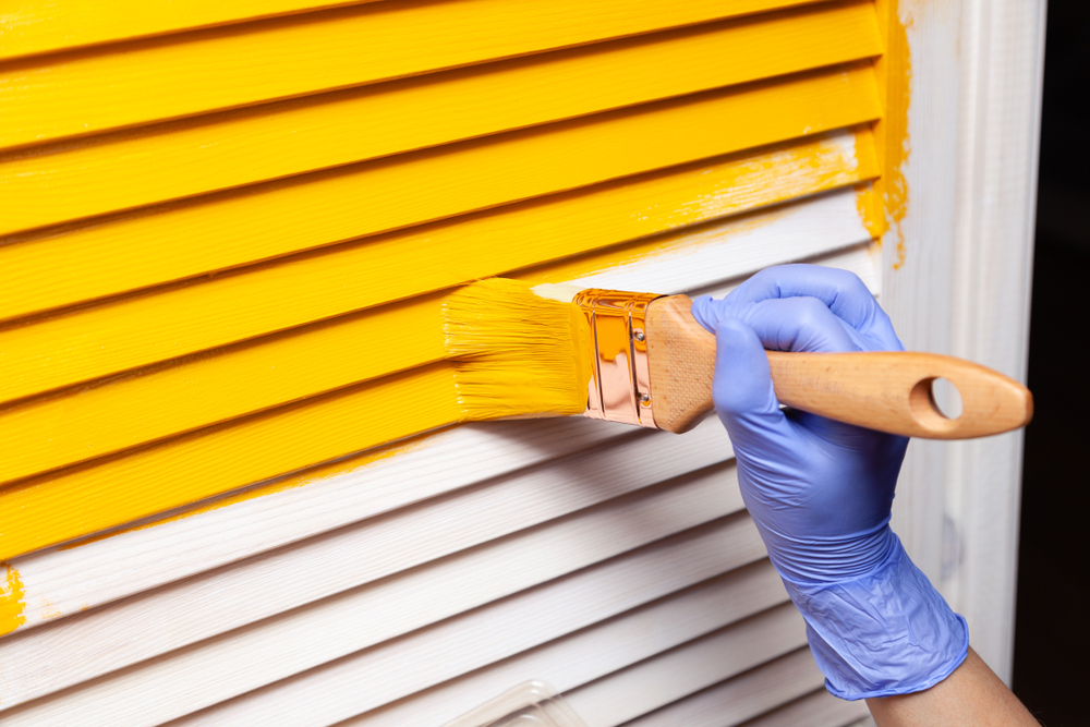 Closeup,Woman,Hand,In,Purple,Rubber,Glove,With,Paintbrush,Painting